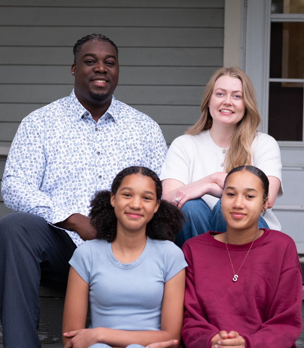 Luc with his family on their porch steps in Spokane